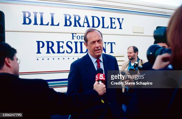 American politician Bill Bradley speaks to journalists next to his bus during his campaign for the Democratic presidential nomination, 2000.