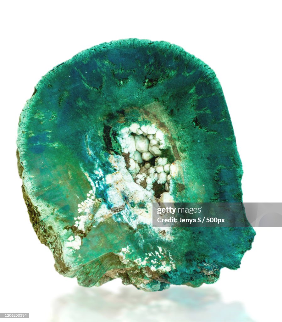 Raw emerald stone on white background