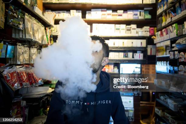 Person exhales vapor while using an electronic cigarette device at a smoke shop in New York, U.S., on Wednesday, Jan. 8, 2020. The U.S. Food and Drug...