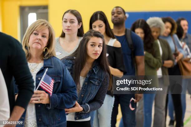 impatient woman waiting to vote - voting line stock pictures, royalty-free photos & images