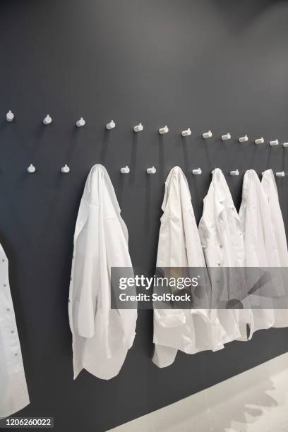 medical protective clothing - coat stand stock pictures, royalty-free photos & images
