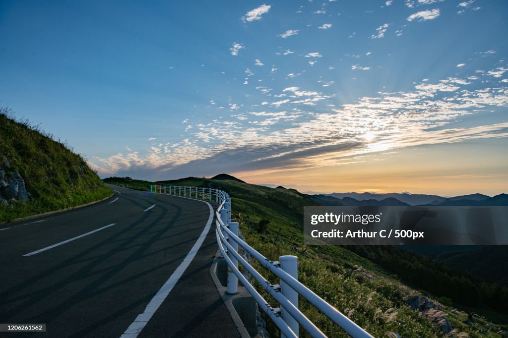Road overlooking mountain landscape at sunrise
