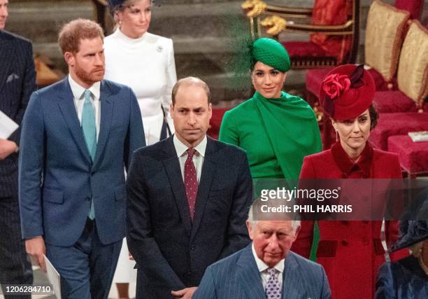 Britain's Prince Harry, Duke of Sussex and Britain's Meghan, Duchess of Sussex follow Britain's Prince William, Duke of Cambridge and Britain's...