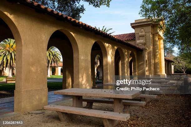 Empty chairs and tables sit outside the usually bustling student union during a quiet morning at Stanford University on March 9, 2020 in Stanford,...