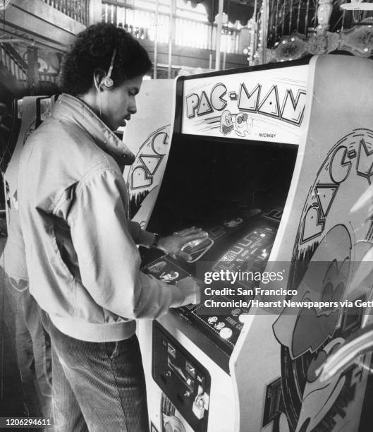 Brian Allen listens to his Walkman while playing Pac-Man at the Pier 39 arcade in San Francisco.