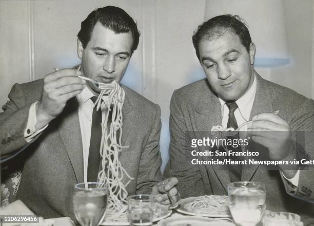 Rock Hudson and boxer Rocky Marciano eat spaghetti at the Fairmont Hotel in January 1958