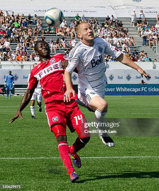 Jordan Harvey of the Whitecaps FC battles with Patrick Nyarko of the Chicago Fire during the first half of MLS Soccer on August 07, 2011 at Empire...