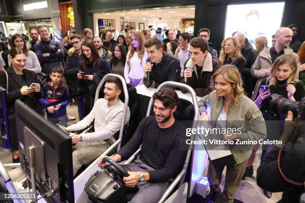 Marco Fantini, Ignazio Moser and Irene Saderini attend the Reveal Of Scuderia AlphaTauri's New Car Design At The Façade Of La Rinascente on February...