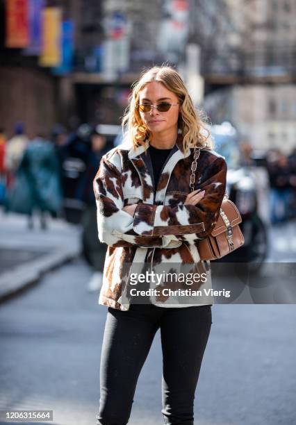 Claire Rose Cliteur is seen wearing jacket with cow print, brown bag outside Michael Kors during New York Fashion Week Fall / Winter 2020 on February...