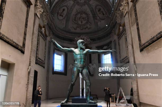 The visitors admires the copy of "Poseidon" greek statue during the "Ulysses - The Art And The Myth" exhibition preview Musei San Domenico on...
