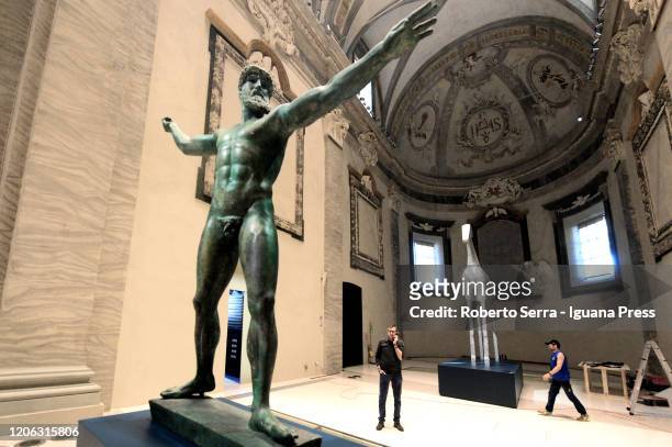 The visitors admires the copy of "Poseidon" greek statue during the "Ulysses - The Art And The Myth" exhibition preview Musei San Domenico on...