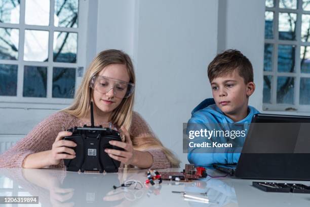 enthusiastic schoolers  testing their engineering creation at home - student inventor stock pictures, royalty-free photos & images