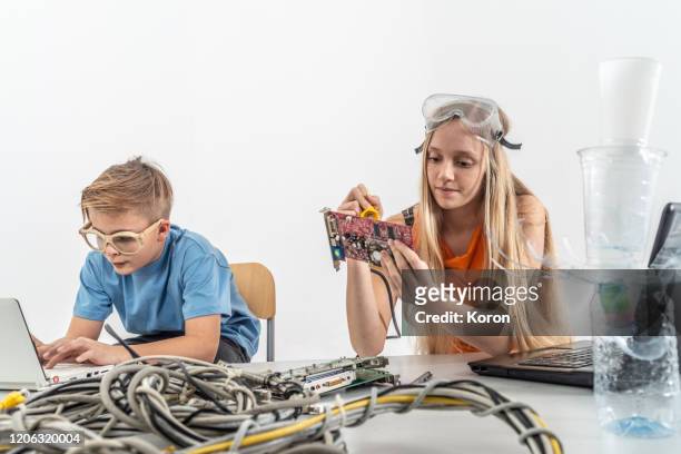 two school student working on science project experimenting with connections - student inventor stock pictures, royalty-free photos & images