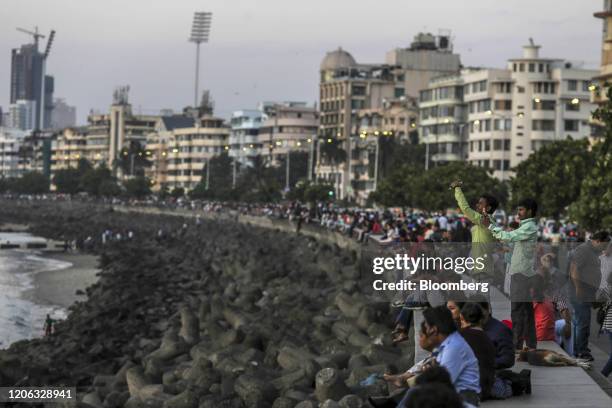 People gather at Marine Drive in Mumbai, India, on Monday, March 9, 2020. India's central bank seizing control of beleaguered Yes Bank Ltd. Last week...