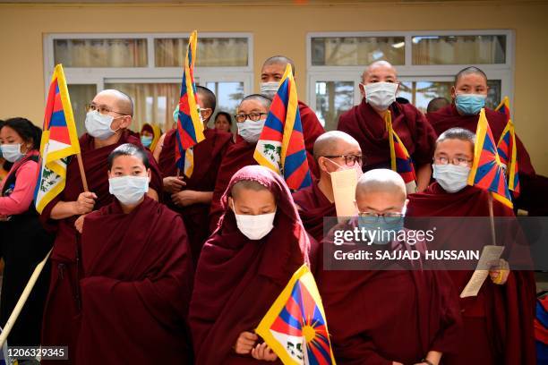 Tibetans living in exile attend an event to mark the 61st anniversary of the Tibetan Uprising Day that commemorates the 1959 Tibetan uprising, in...