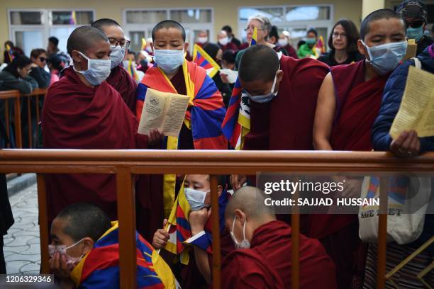 Tibetans living in exile attend an event to mark the 61st anniversary of the Tibetan Uprising Day that commemorates the 1959 Tibetan uprising, in...