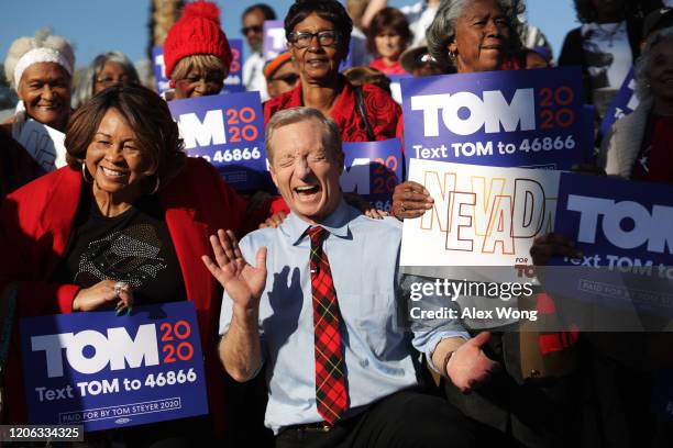 Democratic presidential candidate Tom Steyer reacts as he poses with supporters during a campaign event at Martin Luther King Jr. Senior Center...