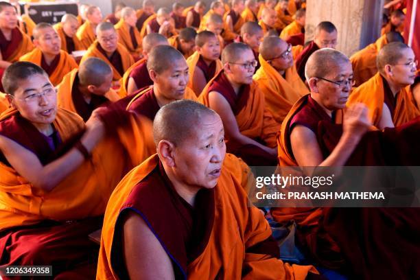 Exiled Tibetan Buddhist nuns pray at Choeling Monastery in Kathmandu on March 10 a date that marks the 61st anniversary of the Tibetan Uprising Day...