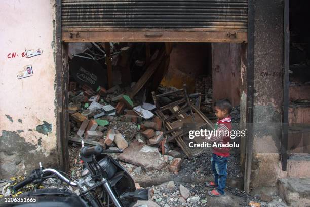 Kid playing outside the gutted shop in Shiv Vihar which become the haunted colony for muslims, the worst affected locality of Delhi riots, many...