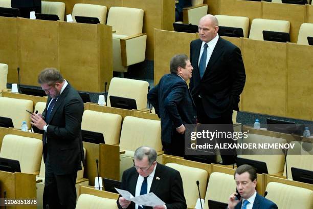 Lawmakers, including former wrestler Alexander Karelin, attend the second reading of the constitutional reform bill during a session of the State...