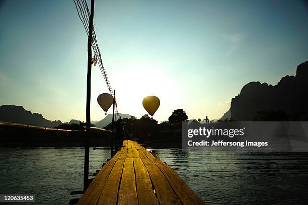 hot air rises, vang vieng - vang vieng balloon stock pictures, royalty-free photos & images