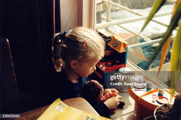 girl playing with doll and toy kitchen - dolls ストックフォトと画像