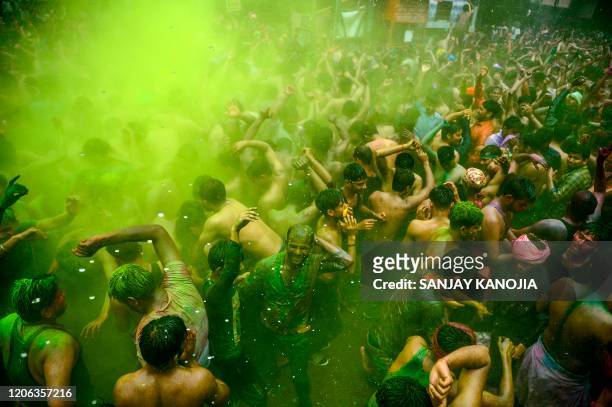 Revellers dance as they celebrate Holi, the spring festival of colours, in Allahabad on March 10, 2020.