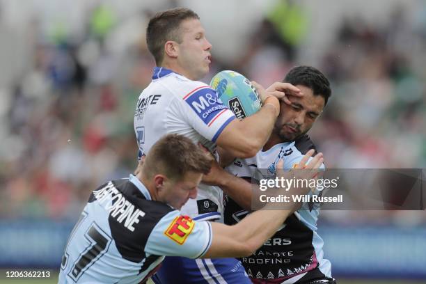 Jack Cogger of the Bulldogs is tackled by Teig Wilton and Braydon Trindall of the Sharks during Day 2 of the 2020 NRL Nines at HBF Stadium on...