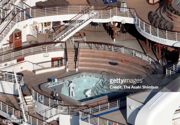 In this aerial image, workers spray sanitariser on the cruise ship Diamond Princess xxx on February 13, 2020 in Yokohama, Kanagawa, Japan.