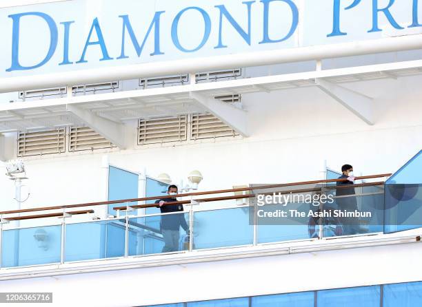 Workers wipe handrails on cruise ship Diamond Princess at Daikoku Pier of Yokohama Port on February 13, 2020 in Yokohama, Kanagawa, Japan.