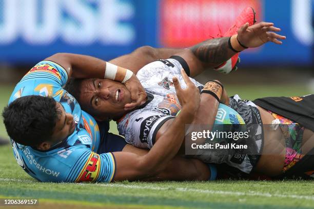 Michael Chee Kam of the Wests Tigers gets tackled by Tyrone Peachey of the Titans during Day 2 of the 2020 NRL Nines between the Gold Coast Titans...