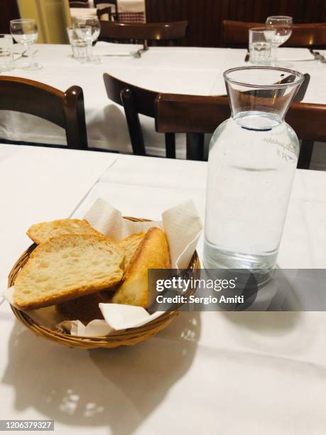 bread basket and water carafe on italian restaurant table - carafe stock pictures, royalty-free photos & images