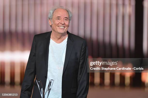 Maxime Le Forestier celebrates after receiving a special honour award during the 35th 'Les Victoires De La Musique' Show At La Seine Musicale on...