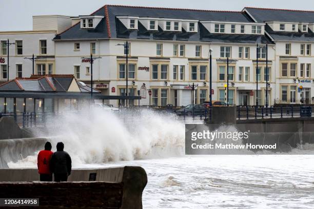 Waves crash against the harbour wall on February 15, 2020 in Porthcawl, United Kingdom. The Met Office have issued an amber weather warning for rain...