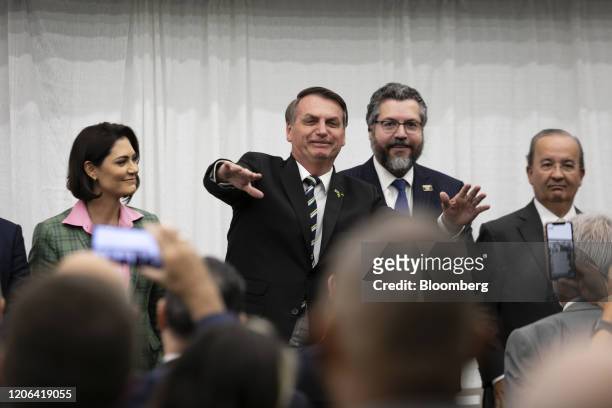 Jair Bolsonaro, Brazil's president, center left, gestures while speaking during an event with supporters at the Miami Dade College Auditorium in...