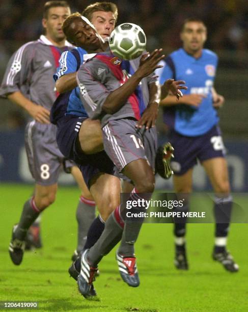 L'attaquant lyonnais Sidney Govou est à la lutte avec l'attaquant du Leverkusen Ulf Kirsten , le 18 septembre 2001 au stade de Gerland à Lyon, lors...