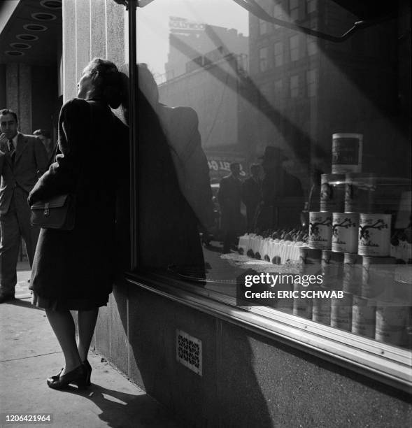 Young woman waits in front of the famous Lindy's restaurant, especially well known for its cheesecake, in February 1947, on 1626 Broadway in...
