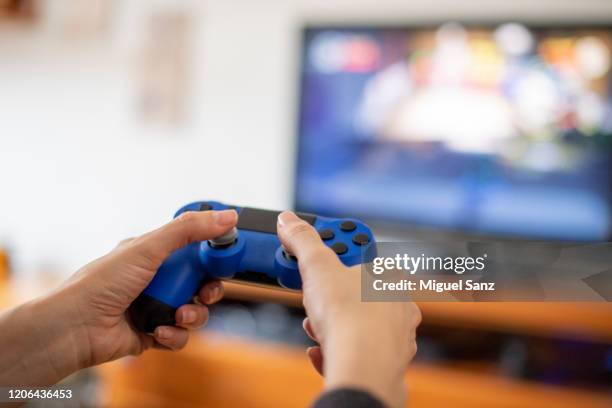 playing on console with videogames joystick - smart tv stock pictures, royalty-free photos & images