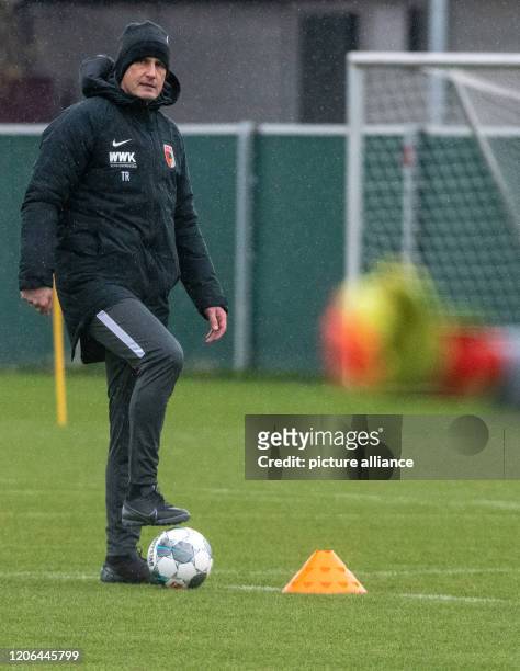 March 2020, Bavaria, Augsburg: Heiko Herrlich plays with a ball on the training ground of FC Augsburg. The 48-year-old led his first training session...