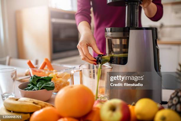 preparing cold pressed juice - juice extractor stock pictures, royalty-free photos & images