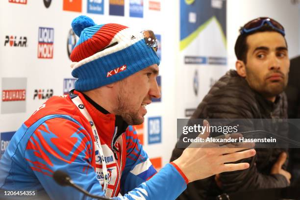 Alexander Loginov of Russia talks to the media next to Martin Fourcade of France during a press conference after the Men 10 km Sprint Competition at...