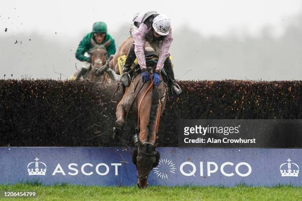 Joshua Moore riding Traffic Fluide fall at the last when challenging Riders On The Storm at the last fence at Ascot Racecourse on February 15, 2020...
