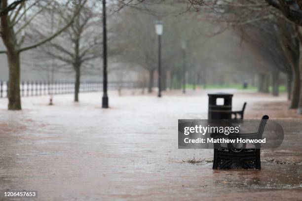 Pathway submerged in water as the River Usk breaches its banks on February 15, 2020 in Brecon, United Kingdom. The Met Office have issued an amber...