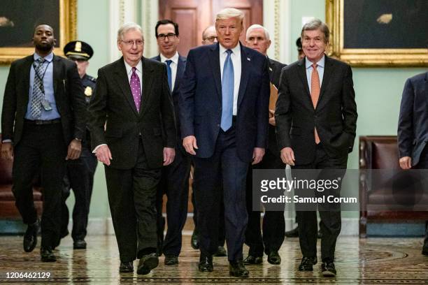 President Donald Trump arrives at the US Capitol to attend the Republicans weekly policy luncheon on March 10, 2020 in Washington, DC. He is flanked...