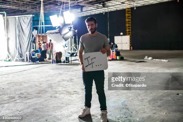 man holding a sign of empowering self - film set stock pictures, royalty-free photos & images