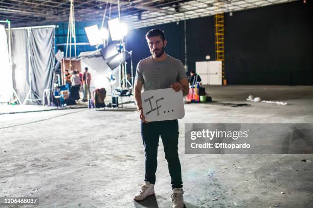 man holding a sign of empowering self - film set 個照片及圖片檔