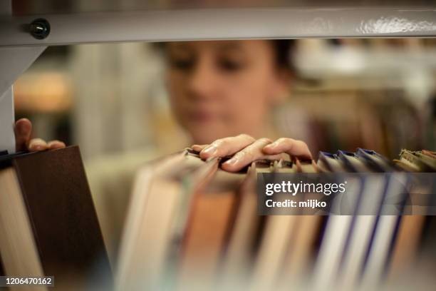 Library Tutorial On Arranging Books 26 Young Female Librarian Arranging Books On Library Shelves Stock ...
