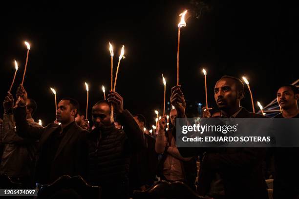 Relatives and colleagues of the Ethiopian Airlines' crew victims hold candles during the commemoration of the first anniversary of the Ethiopian...