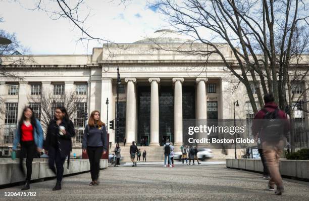 Students and pedestrians walk though MIT's campus in Kendall Square in Cambridge, MA on March 10, 2020. Some colleges have moved all classes online...