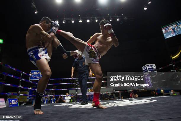 Boxers in action during the Thai Boxing match that was held without spectators as a preventive measure against the spread of the COVID-19 coronavirus...